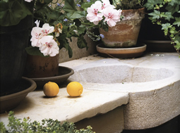 Antique reclaimed stone basin sink salvaged restored and installed in this traditional style Mediterranean home.